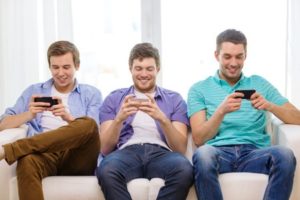 Three friends playing mobile app games